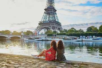 Beautiful twin sisters near the Eiffel tower in Paris, France