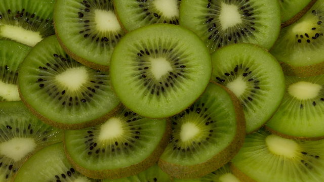 Fresh Kiwi Slices Close-up Rotating. Seamless Looping Motion.