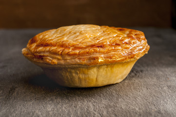 Whole Cooked Pie on a Grey Background