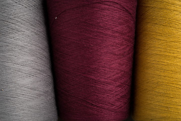 Close Up of Grey, Maroon, and Yellow Sewing Thread