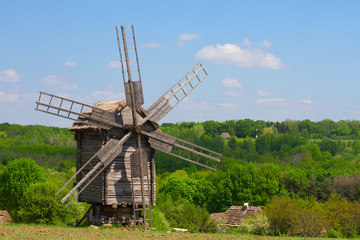 Fototapeta na wymiar wooden windmill against the blue sky