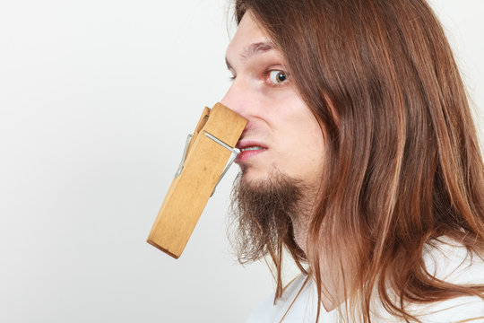 Man with clothespin on nose