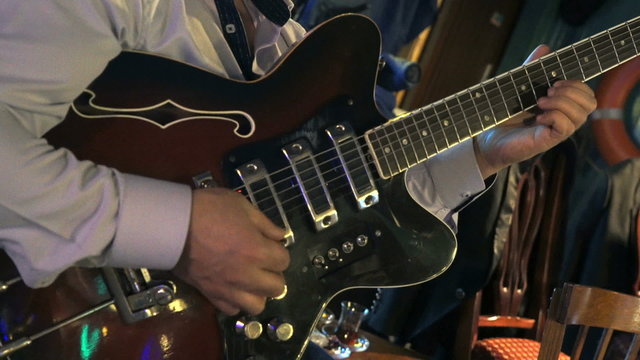 Guitarist playing on electric guitar at a concert