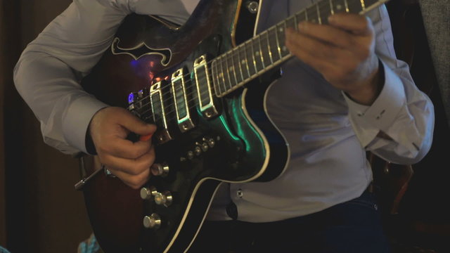 Guitarist playing on electric guitar at a concert
