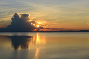sunset and clouds reflection over the dam.