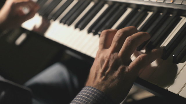 Man adjusts the synthesizer before the concert