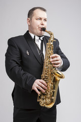 Obraz premium Music Concept and Ideas. Portrait of Caucasian Player in Suit