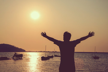 Man playing on the beach at the sunset time.