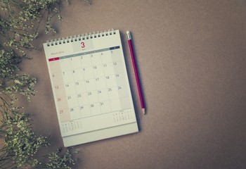 March Calendar 2016 and old flower on wood table ,vintage filter