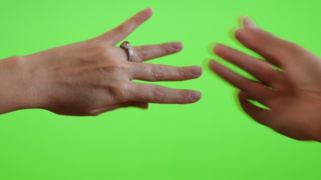 Male hand gives new ring in front of green screen chroma key background 4K 3840X2160 UltraHD footage - Greenscreen woman and man hands ring displaying 4K 2160p UHD video 
