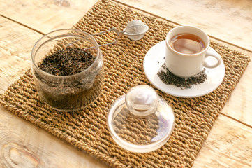 Tea set on the wooden table at sunny morning