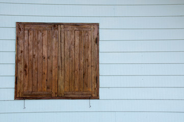 Naklejka na ściany i meble Wooden window with blue wall