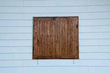 Wooden window with blue wall