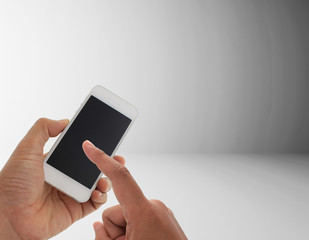 hand holding the smartphone on gray color left to right gradient