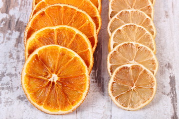 Slices of dried lemon and orange on old wooden background