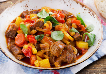 Stew on old wooden table.