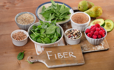 Foods rich in Fiber on a wooden table. - obrazy, fototapety, plakaty