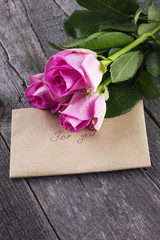 Pink roses and message against a dark background