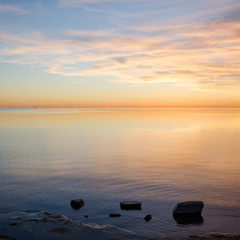 Fototapeta na wymiar Bright sunset view with calm water