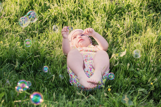 happy child with soap bubbles outdoor
