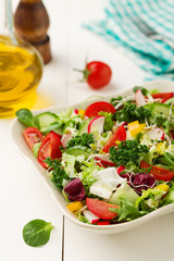 Spring salad with fresh vegetables from radishes and kale