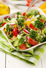 Spring salad with fresh vegetables from radishes and kale