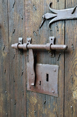 Antique lock with a hasp on the timber entrance