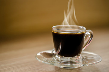 Hot black coffee in glass cup.