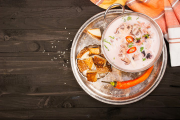 Soup from seafood: octopus, shrimp, mussels, squid. Top view.