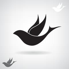 Stylized black silhouette of a flying bird. 