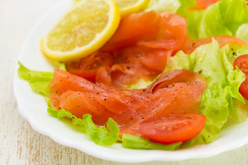 salad with smoked salmon on white dish