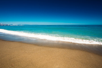 Fototapeta na wymiar Sea Ocean Waves Wash Over Golden Sand Background