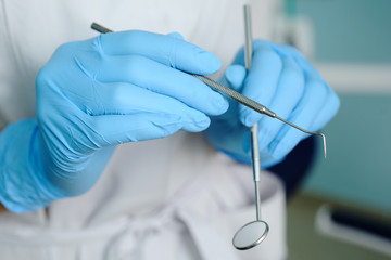 close-up of dentist hand with dental tools