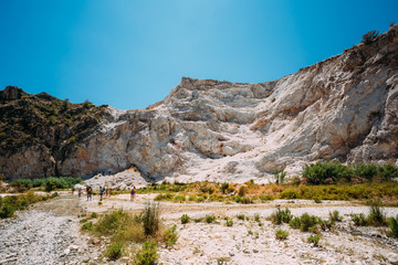 People walk on the tourist route by the Rio Chillar River near N