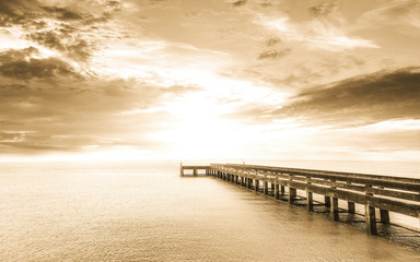 Obraz premium abstract background in sepia tone : long Exposure : sunset with long bridge ans smooth water surface
