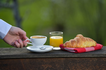 Breakfast coffee, orange juice and croissant