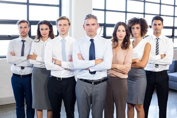Obraz premium Businesspeople standing with arms crossed