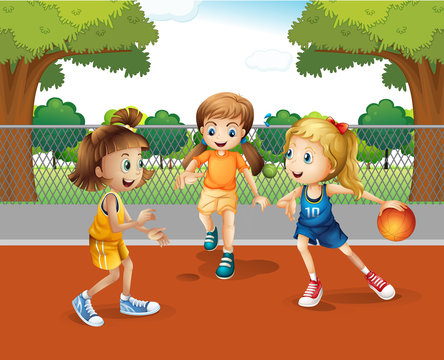Three girls playing basketball in the court