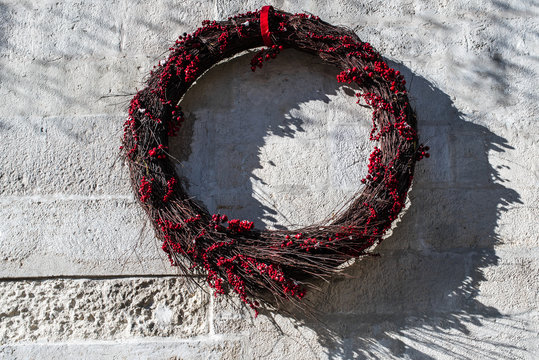 Flower wreath hanging against vintage white background