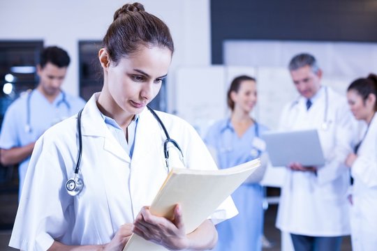 Female doctor checking a medical report 