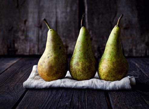 Pears on a napkin on a wooden background