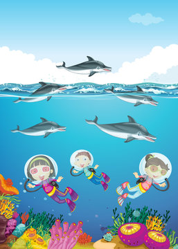 Dolphins and kids swimming under the sea