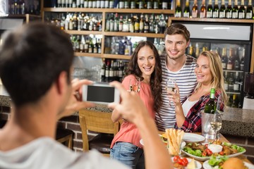 Man taking picture of friends