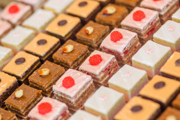 Different delicious sweet cakes on the table. Creamy desserts in