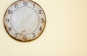 Obraz na płótnie Canvas Antique clock hanging on the wall. Old round watch on a yellow background. 