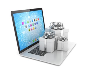 Gift box with ribbon bow on laptop keyboard