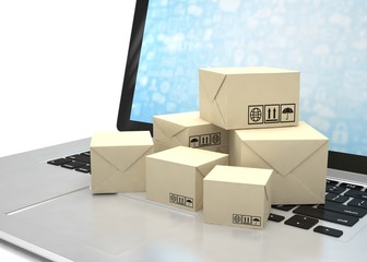 Technology business concept, shipping: cardboard package boxes on laptop