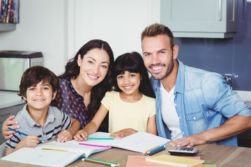 Portrait of happy parents assisting children 