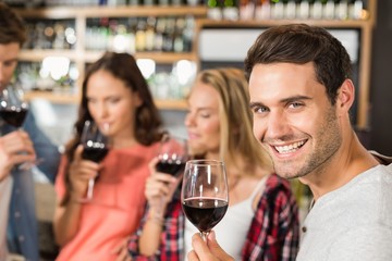 Friends smelling wine