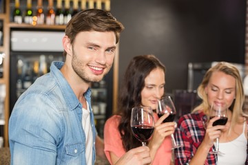 Friends smelling wine